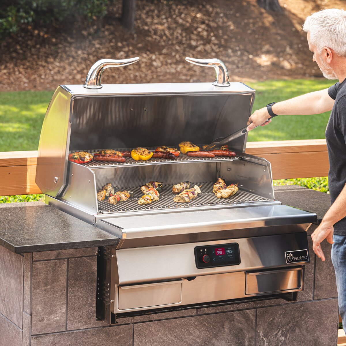 Grilling on a recteq E-Series Built In 1300 in an outdoor kitchen