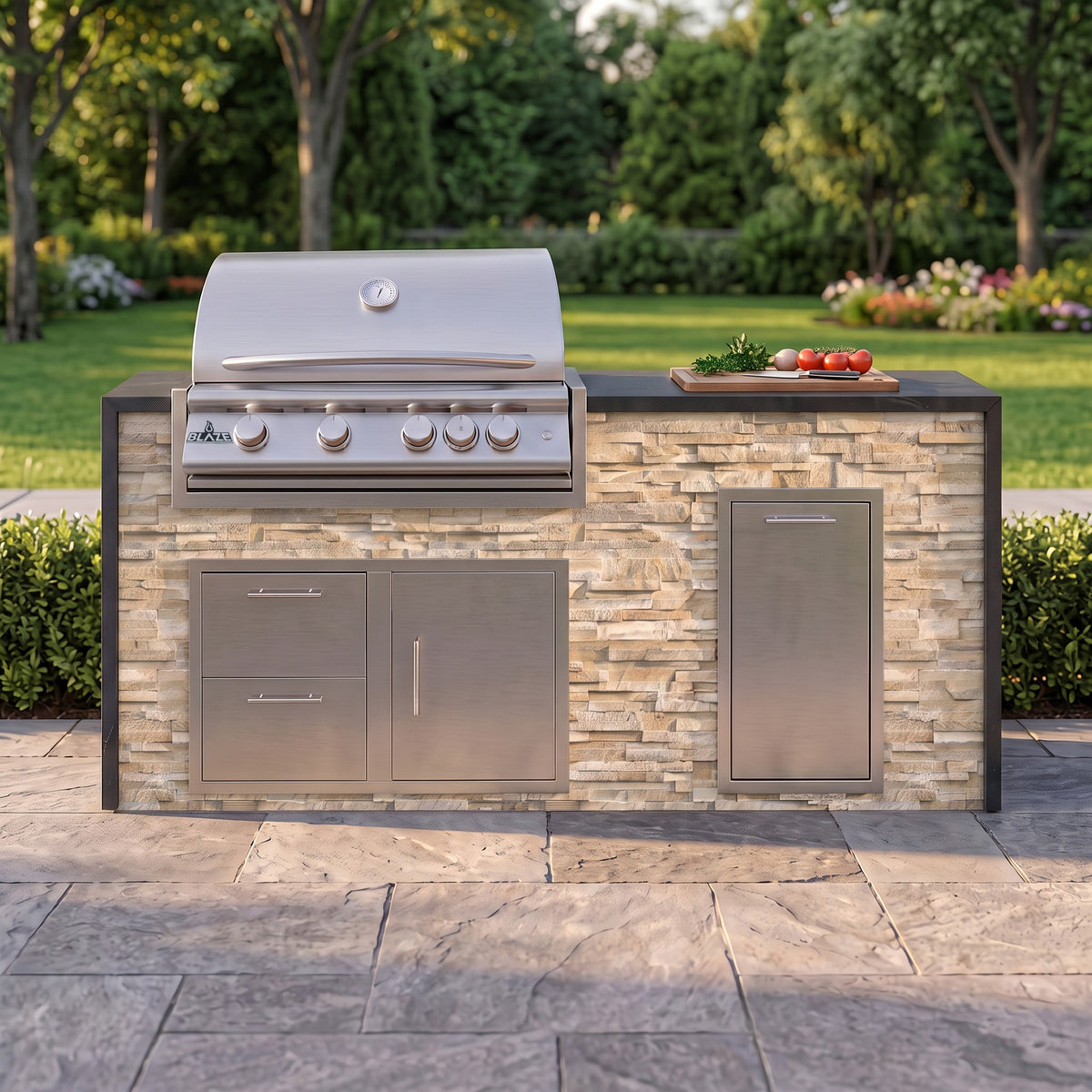 Sunkissed Dune grill island with Charred Onyx granite top and a cutting board of fresh tomatoes on a paver patio facing the lawn