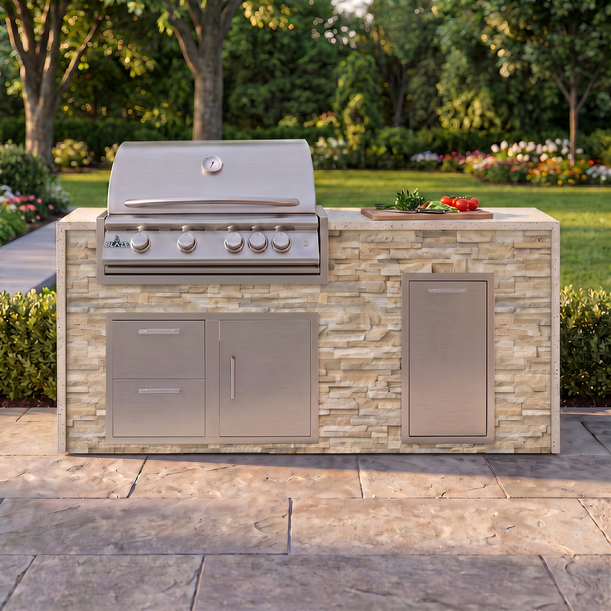 Sunkissed Dune grill island with Frosted Ember granite top and a cutting board of fresh tomatoes on a paver patio facing the lawn