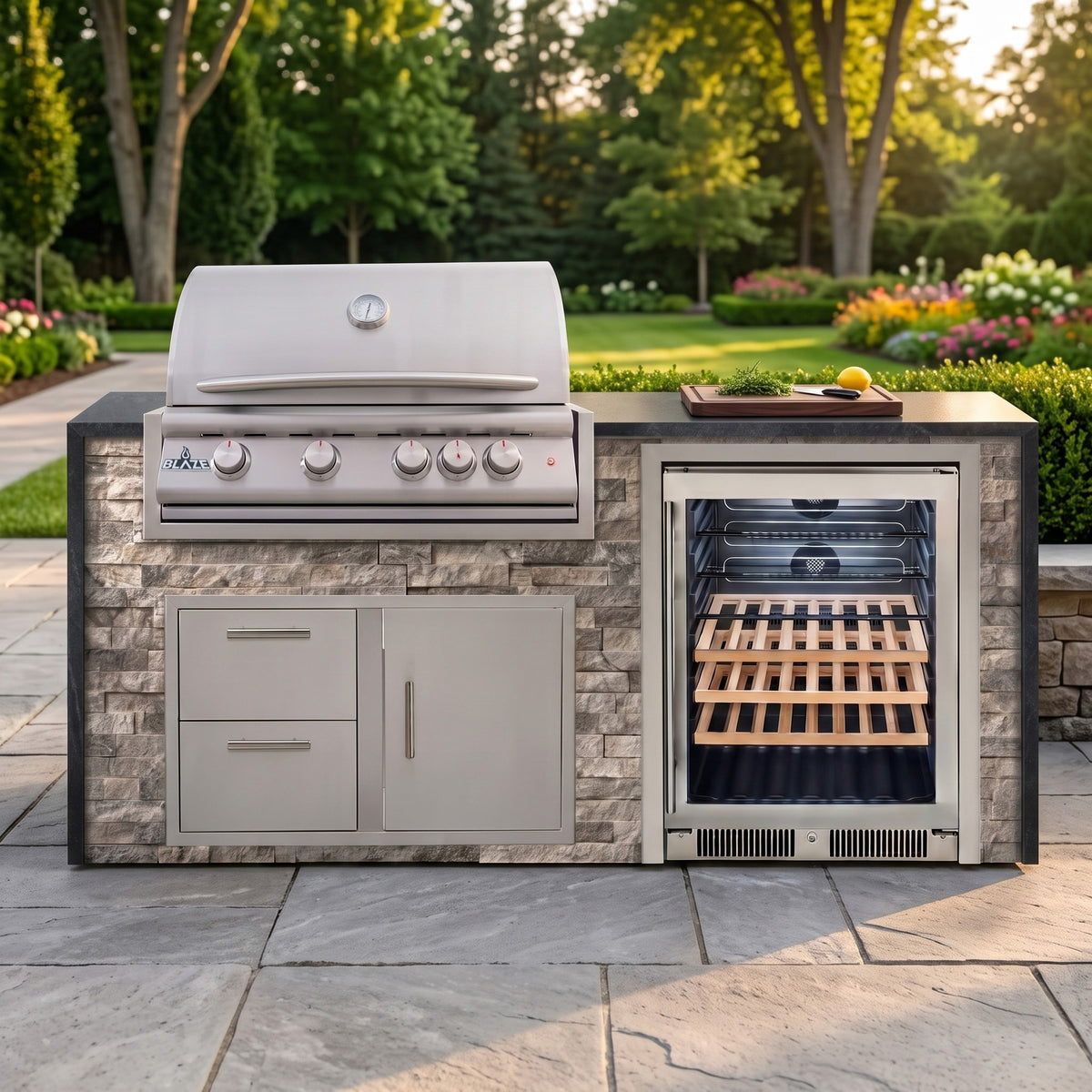 Tuscan Hearth outdoor kitchen with Charred Onyx granite countertop on a stone paver patio beside a backyard garden
