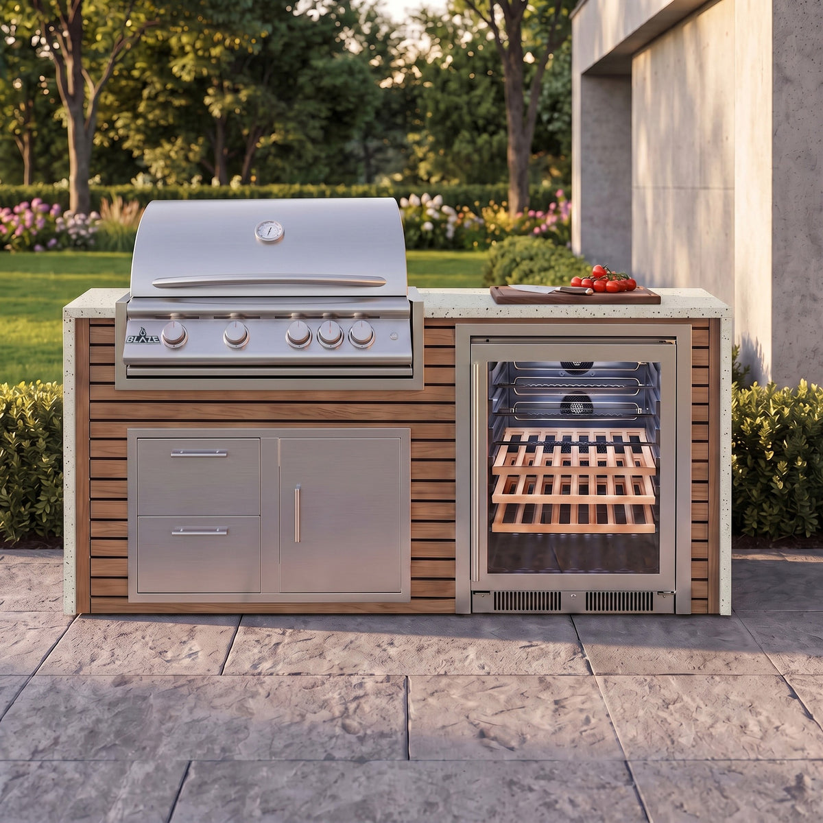 Warmed Acacia outdoor kitchen with Frosted Ember granite countertop on a stone paver patio beside a backyard garden