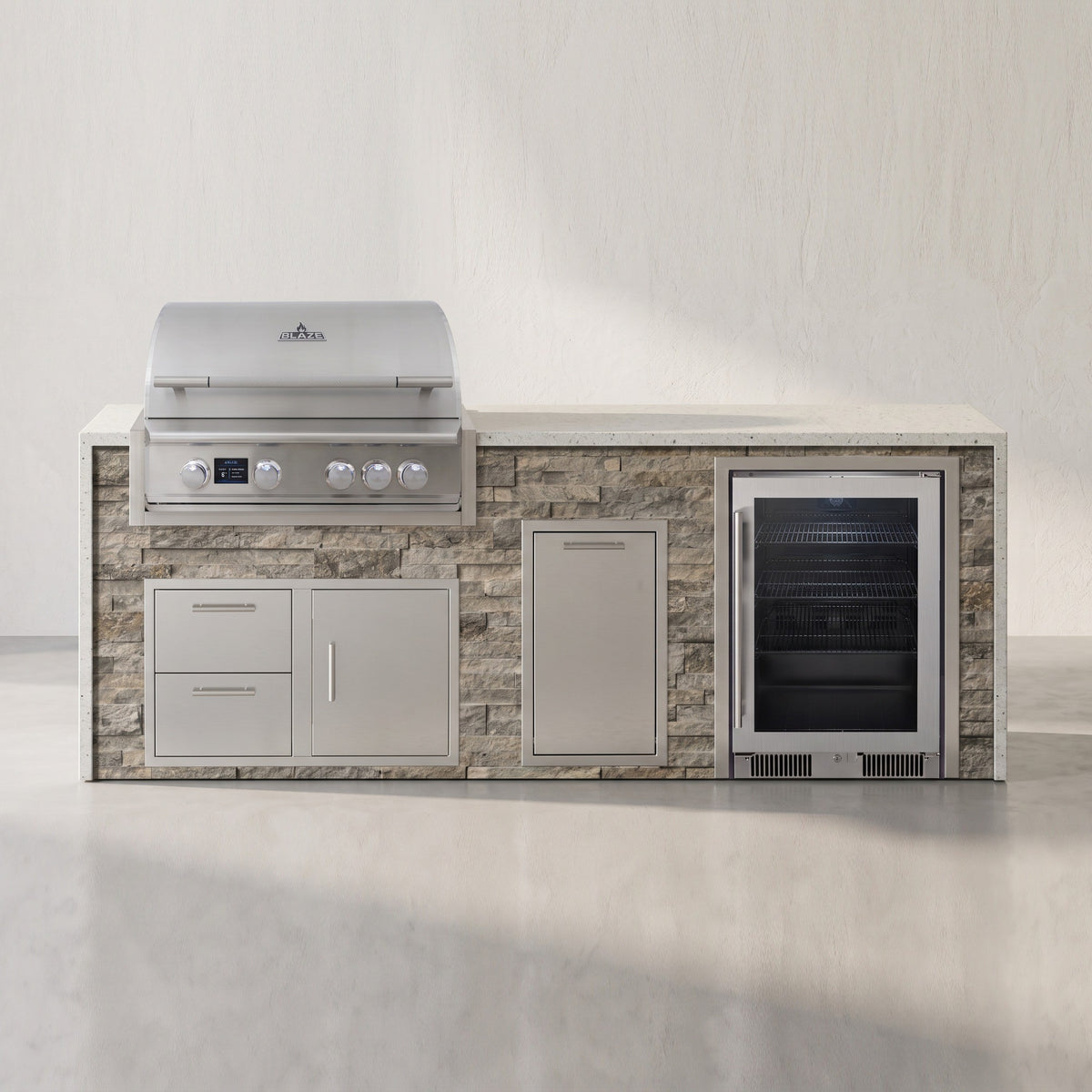 Big Ridge 8 ft Blaze waterfall outdoor kitchen with beverage cooler in Tuscan Hearth stacked stone with Frosted Ember granite