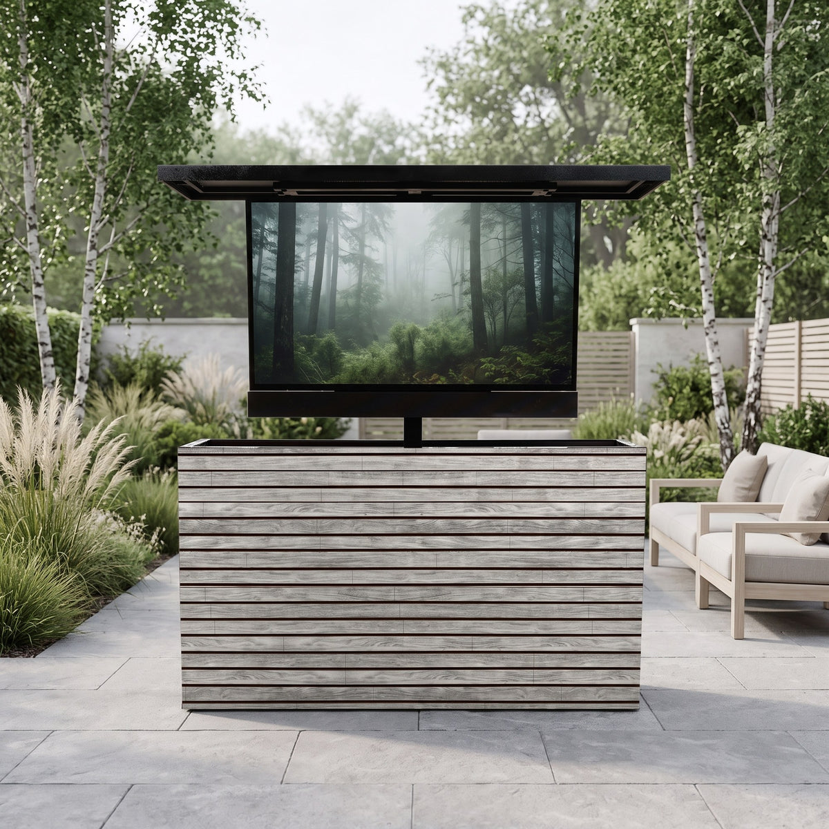 Drifted Cypress 2 inch horizontal ArtisanPlank outdoor TV lift cabinet with the TV raised on a garden terrace with birch trees
