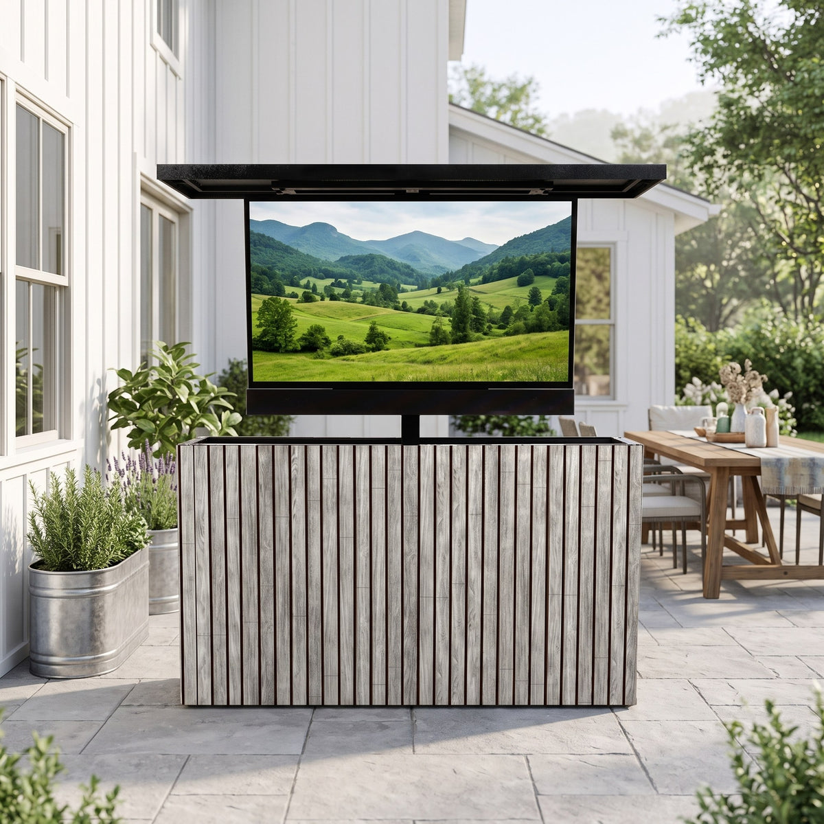 Drifted Cypress 2 inch vertical ArtisanPlank outdoor TV lift cabinet with the TV raised on a farmhouse patio beside a dining table
