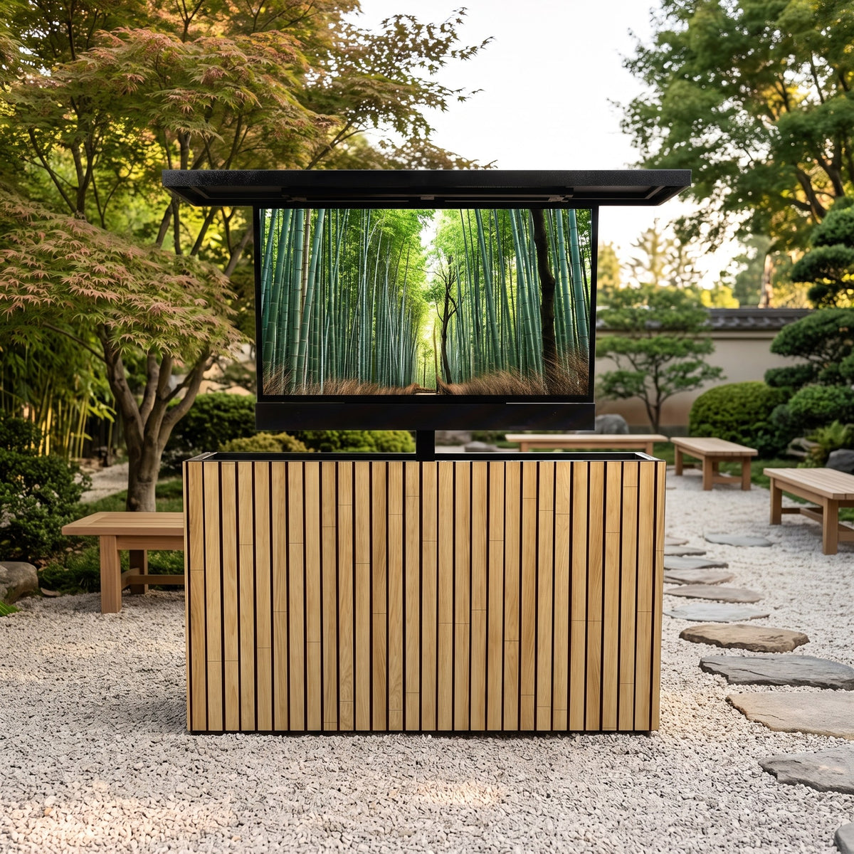 Warmed Acacia 2 inch vertical ArtisanPlank outdoor TV lift cabinet with the TV raised in a Japanese style gravel garden