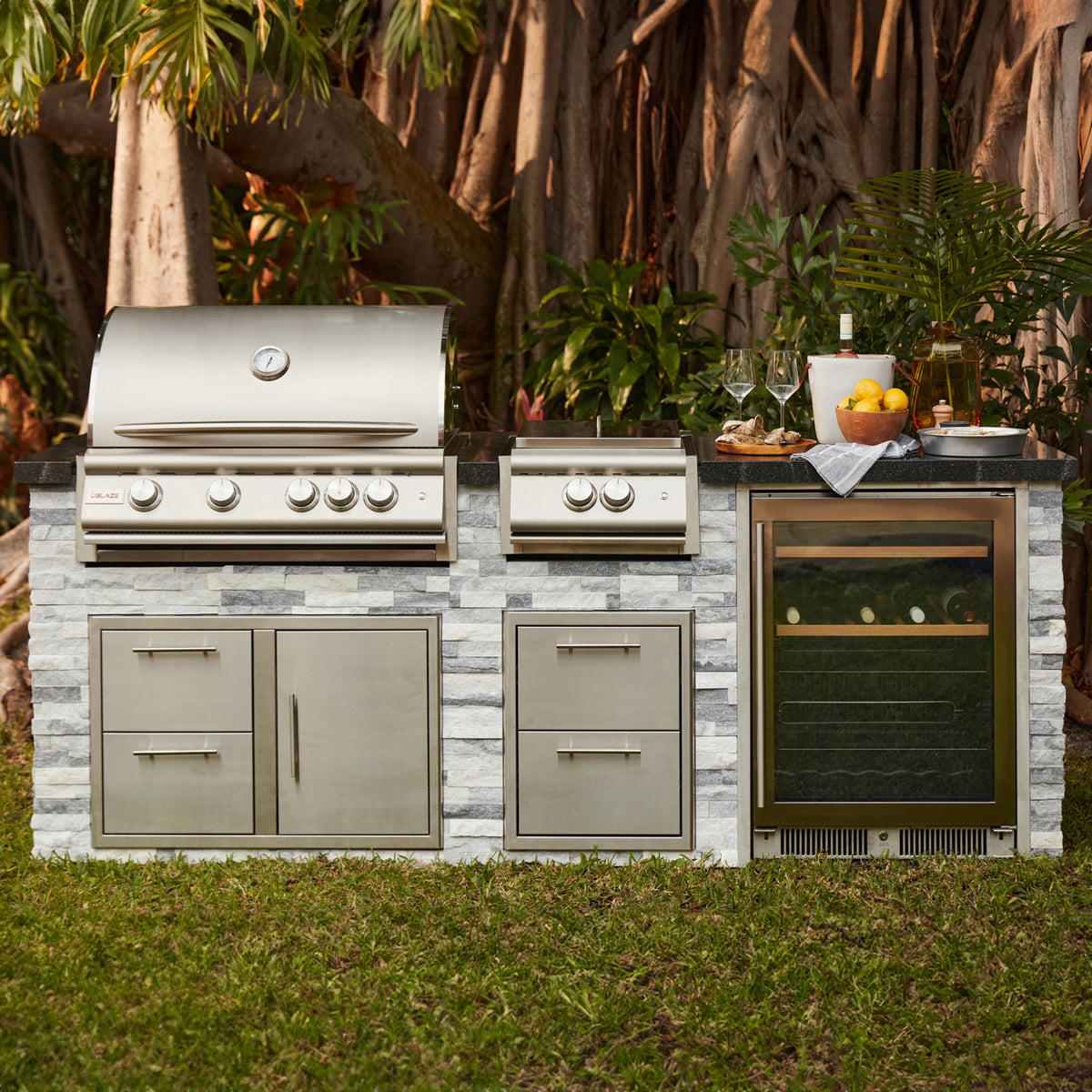 Blaze built in gas grill and side burner in a stone outdoor kitchen