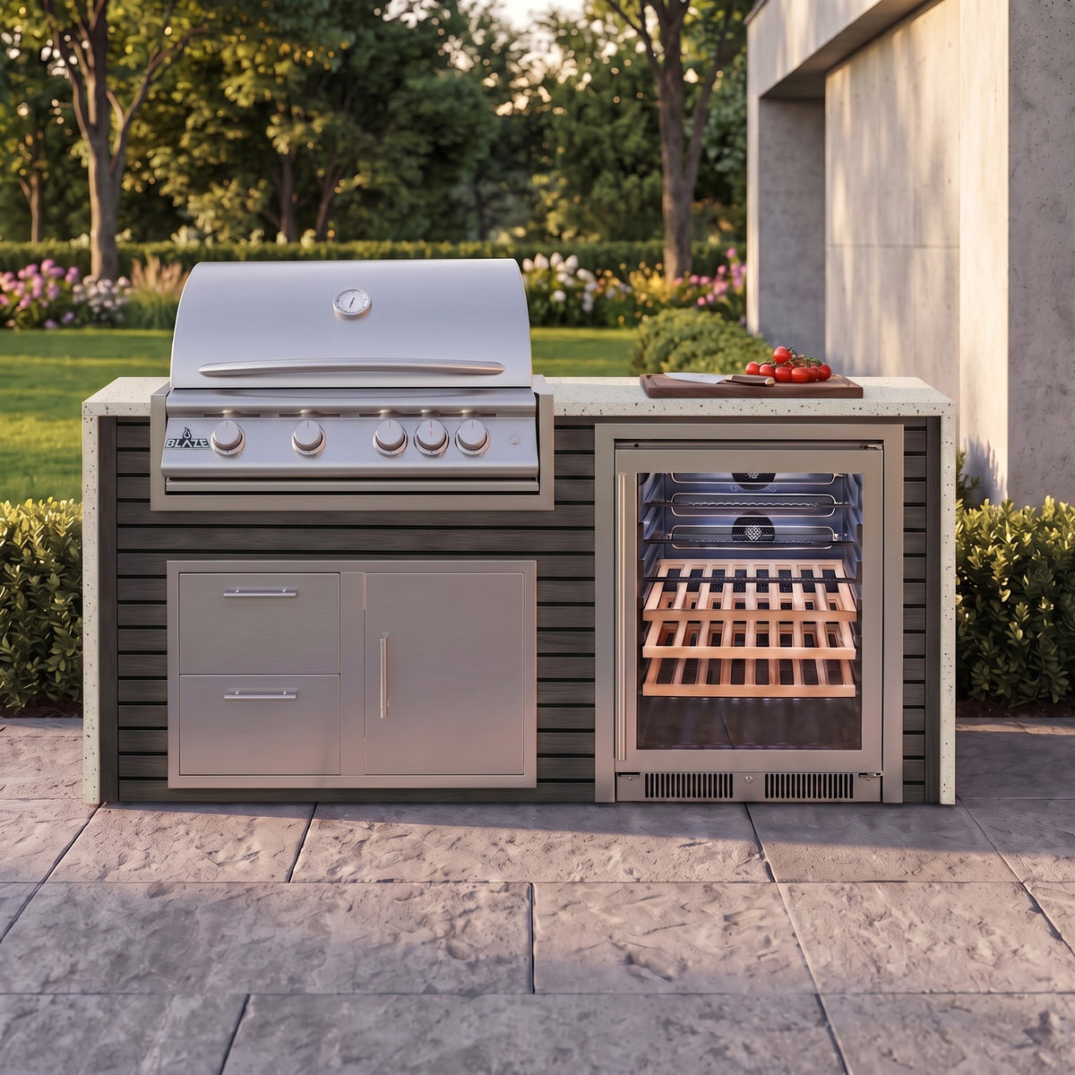 Cindered Ash outdoor kitchen with Frosted Ember granite countertop on a stone paver patio beside a backyard garden