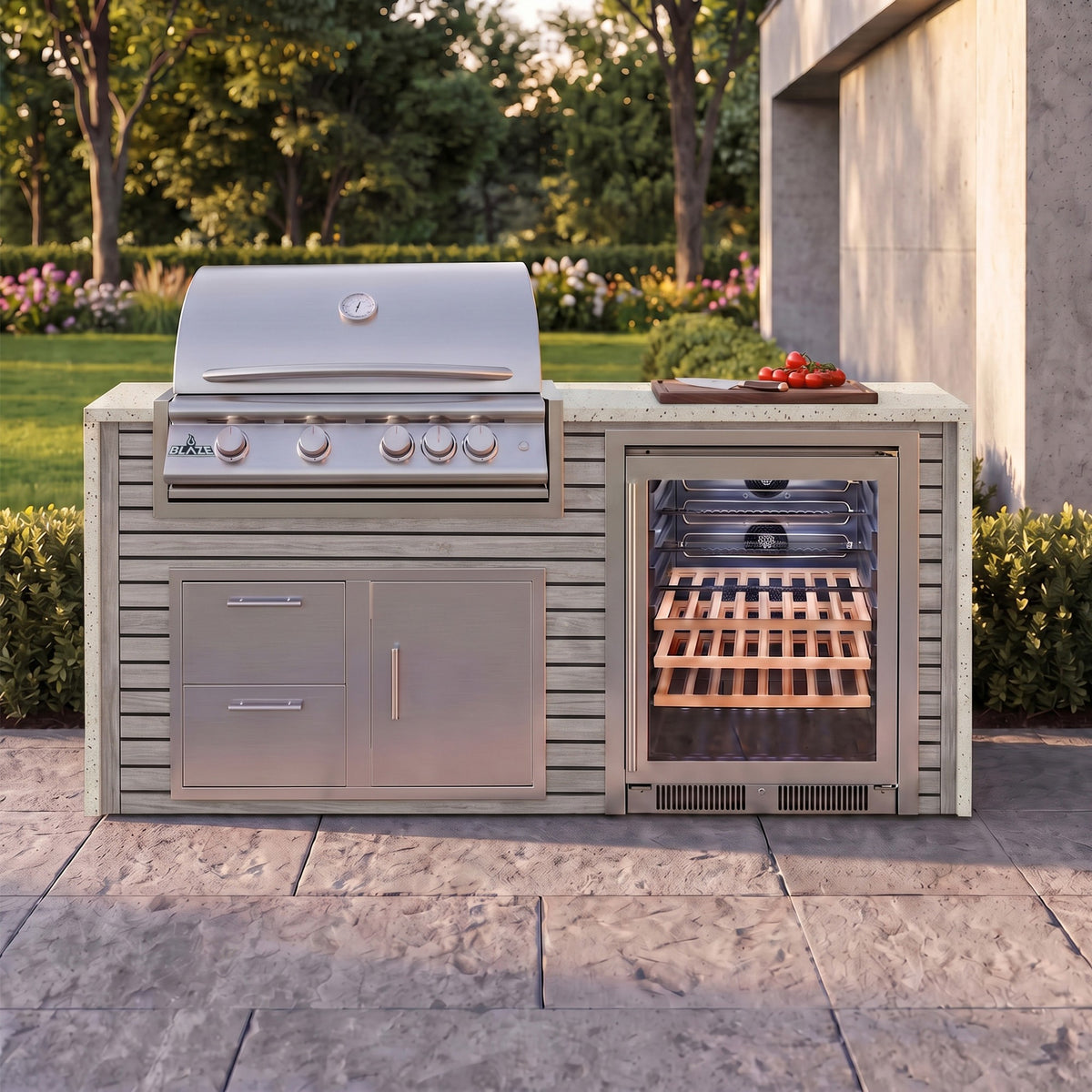 Drifted Cypress outdoor kitchen with Frosted Ember granite countertop on a stone paver patio beside a backyard garden