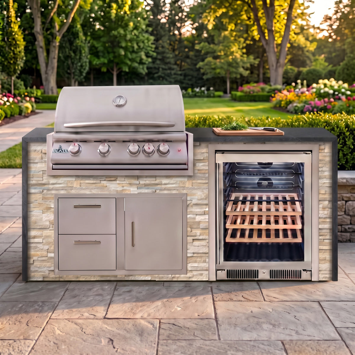 Sunkissed Dune outdoor kitchen with Charred Onyx granite countertop on a stone paver patio beside a backyard garden