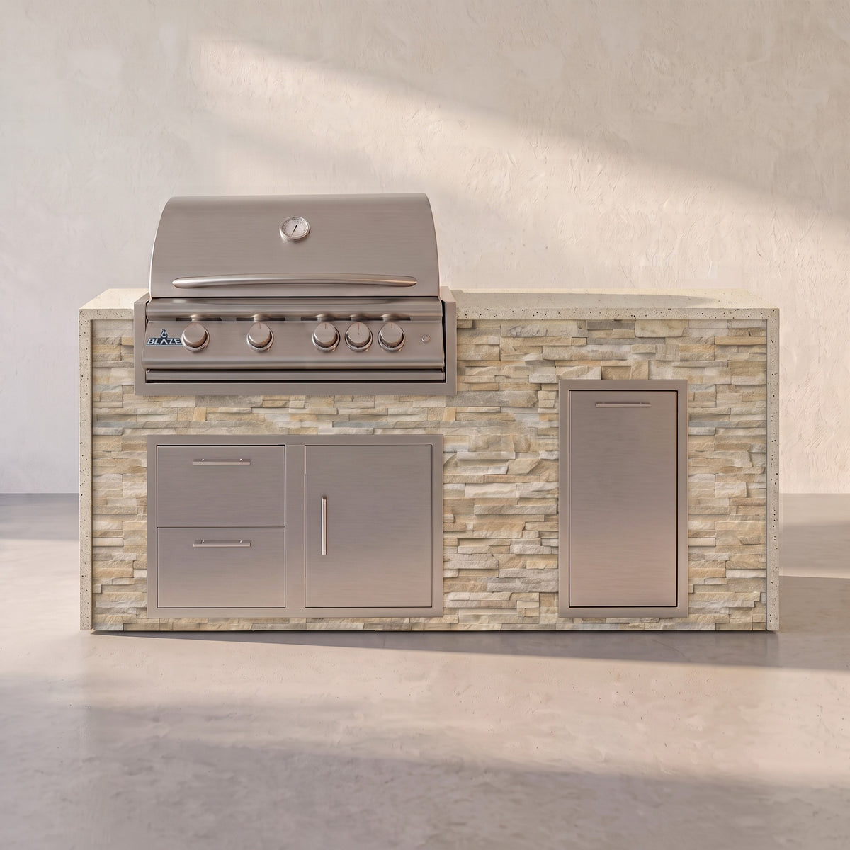 Big Ridge 6 ft Blaze waterfall outdoor kitchen with trash drawer in Sunkissed Dune stacked stone with Frosted Ember granite