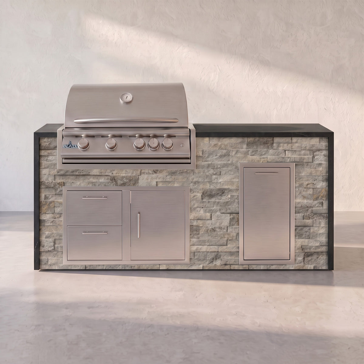 Big Ridge 6 ft Blaze waterfall outdoor kitchen with trash drawer in Tuscan Hearth stacked stone with Charred Onyx granite