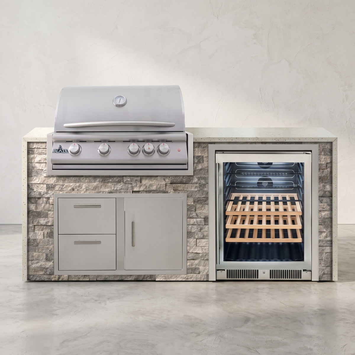 Big Ridge 6 ft Blaze waterfall outdoor kitchen in Tuscan Hearth stacked stone with Frosted Ember granite