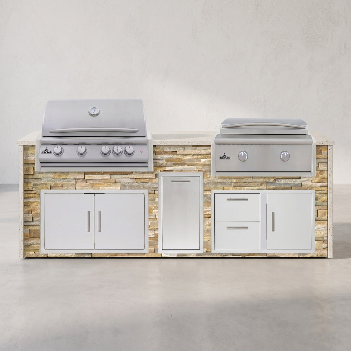 Big Ridge 8 ft Blaze waterfall outdoor kitchen with grill and griddle in Sunkissed Dune stacked stone with Frosted Ember granite