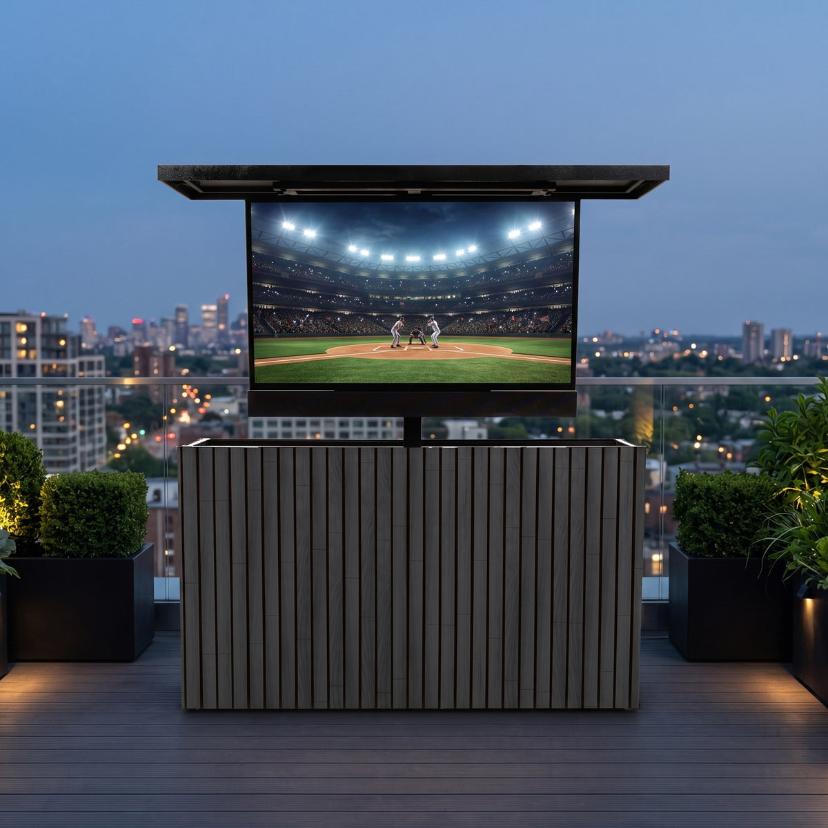 Cindered Ash 2 inch vertical ArtisanPlank outdoor TV lift cabinet with the TV raised on a city rooftop terrace at dusk