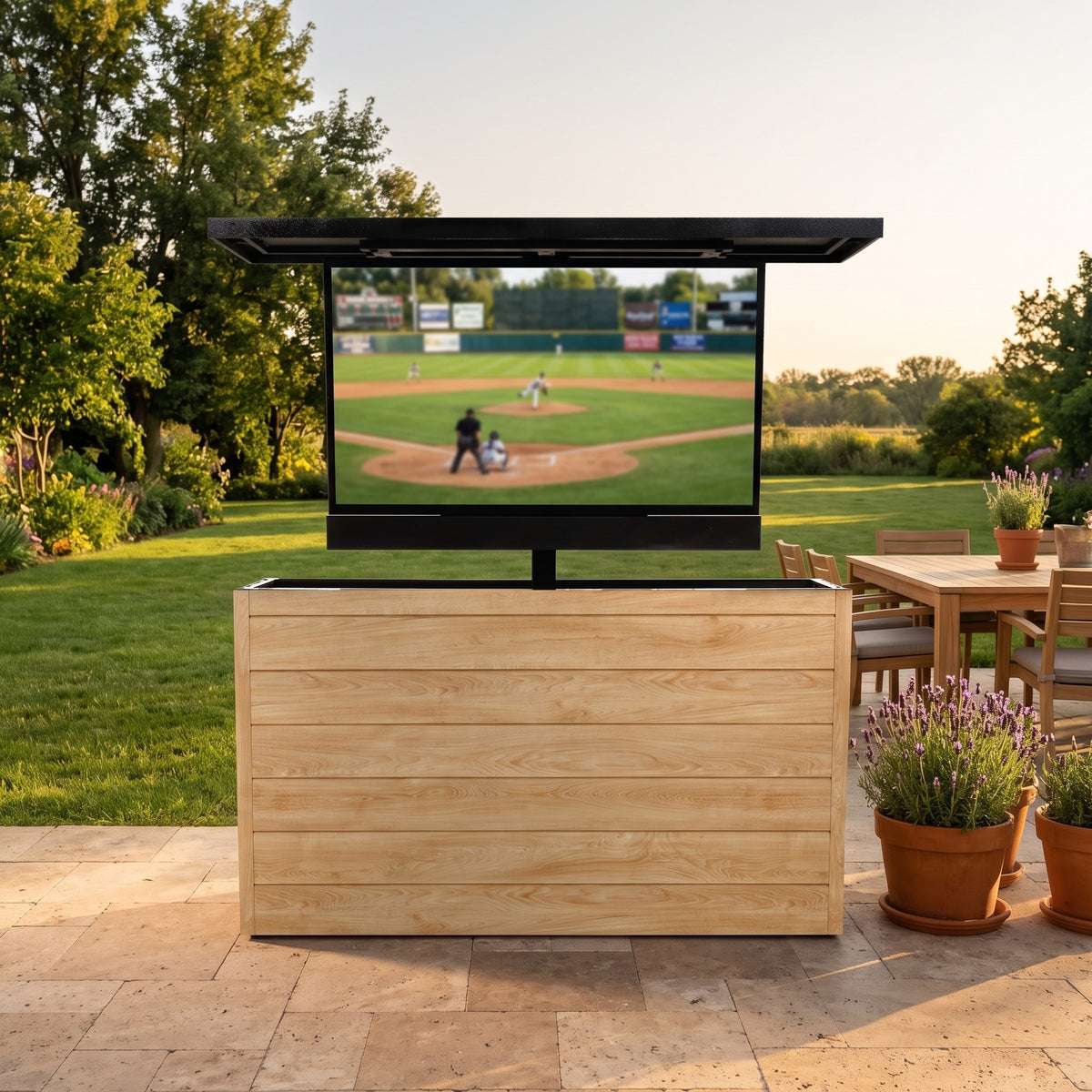 Warmed Acacia 6 inch ArtisanPlank outdoor TV lift cabinet with the TV raised on a travertine patio beside a family lawn